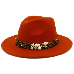 Detail of orange fedora wool hat featuring leopard band and white pearl flower ornaments