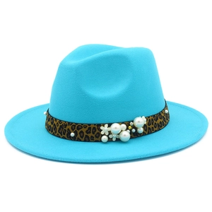 Detail of teal fedora hat with leopard print band, white pearls, and flower accent
