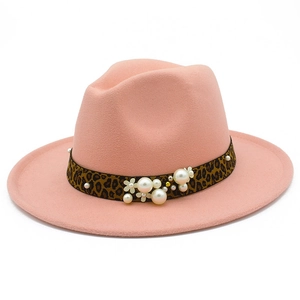 Close-up of pink wool jazz hat with leopard print band and pearl floral ornament