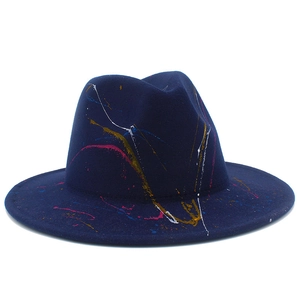 Detail of colorful paint splatter graffiti on navy wool fedora hat with a classic brim