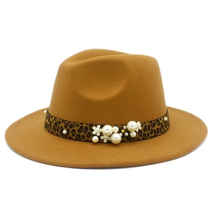 Detail of camel wool fedora with leopard band featuring elegant pearls and floral accents