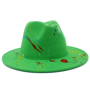 Detailed close-up of vibrant green fedora hat with artistic multi-colored paint splatter