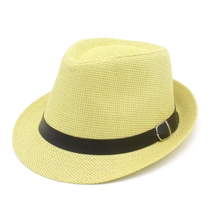 Λεπτομέρεια κίτρινου ψάθινου καπέλου fedora με μαύρη δερμάτινη ζώνη και ασημένια αγκράφα