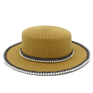 Elegant wide-brim straw boater hat with black ribbon and white pearl trim detailing