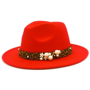 Détail d'un chapeau fedora rouge avec ruban léopard et embellissements de perles élégantes