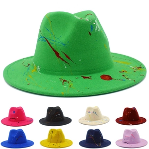 Artistic paint splatter fedora hat in emerald green with multicolor graffiti details