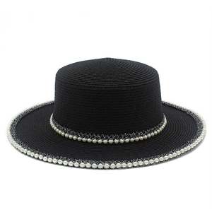 Women's black straw boater hat with elegant pearl trim for beach sun protection