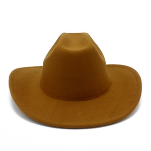 Close-up of the textured brown wool felt fabric and reinforced stitching on a cowboy hat