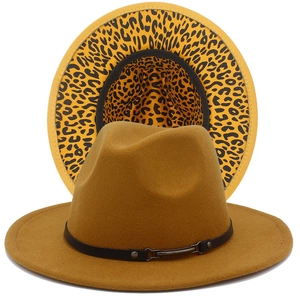 Close-up of ginger wool fedora hat featuring a leopard print brim and black leather buckle band