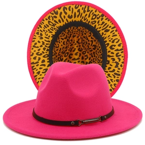 Detail of fuchsia fedora hat featuring leopard print lining and black leather band
