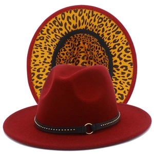 Macro detail of burgundy wide brim fedora with leopard print underbrim and gold studs