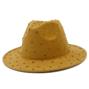 Detail view of ginger yellow wool fedora hat with amber rhinestones and flat brim design