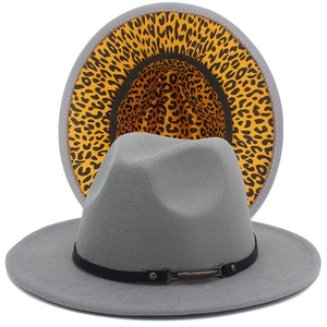 Close-up of light grey fedora hat with leopard print brim and leather band detail