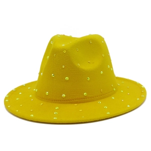 Macro detail of yellow fedora hat with sparkling rhinestones on wool felt material