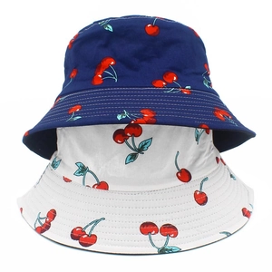 Double-sided cotton bucket hat with red cherry print in navy blue and white colors