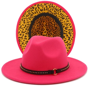 Detail of bright pink fedora hat with leopard print lining and studded black band