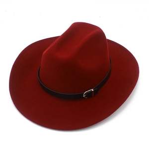 Detail of burgundy wool fedora hat with black leather band and gold buckle accent