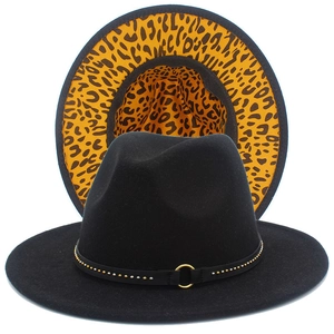 Detail of black fedora with leopard print lining and studded band with golden ring