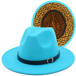Close-up of bright blue wool fedora featuring black leather band and leopard print lining
