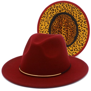Dettaglio del cappello fedora rosso con fodera leopardata ed elegante catena dorata