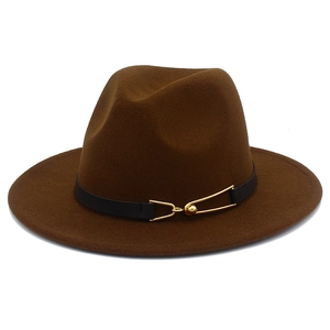 Detail of a brown wool fedora with a black leather band and golden streamlined buckle