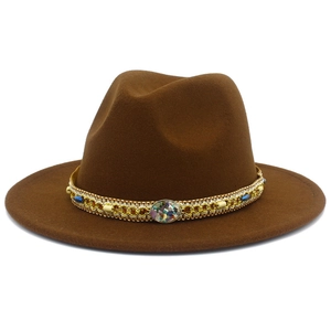Close-up of the bohemian ethnic beaded band and gemstone on a brown wool fedora hat