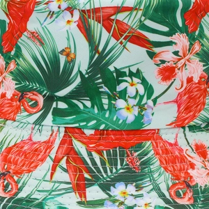 Detailed close-up of tropical flamingo and palm leaf print on a green bucket hat