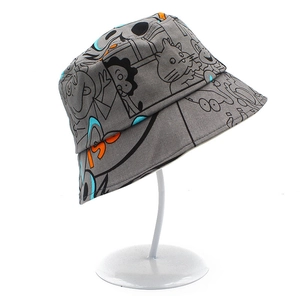 Detail of grey cotton bucket hat with black doodle prints on a white metal display stand