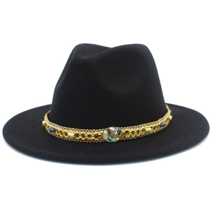 Detail of black wool fedora hat featuring gold braided band and turquoise stone accent