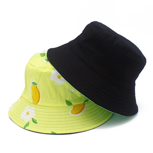 Cotton reversible sun bucket hat for women in solid black and green floral fruit print