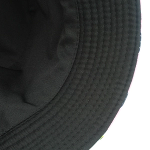 Detail view of the interior structure and stitching of a black cotton bucket hat