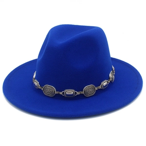 Close-up detail of a bright blue fedora jazz hat with a stylish silver metal chain band