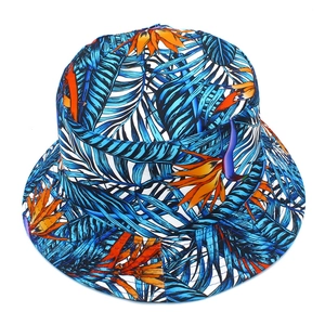 Unisex cotton reversible bucket hat with blue tropical leaves and orange bird of paradise print
