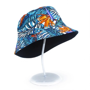 Cotton bucket hat with blue tropical palm leaves and orange bird of paradise prints