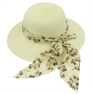 Detail of fine straw weave texture and floral ribbon on elegant wide-brim sun hat