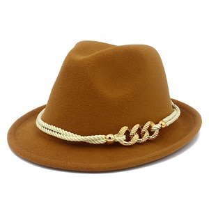 Detail of a brown wool felt fedora featuring a beige braided cord and gold chain accent