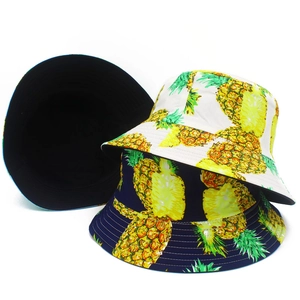 Reversible cotton bucket hat with tropical pineapple print in white and navy blue