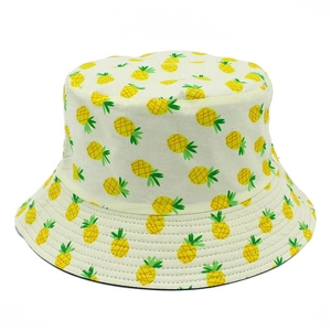 Cotton bucket hat with yellow pineapple print for sun protection in creamy white color