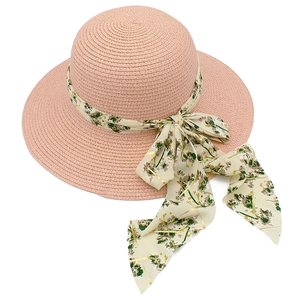 Elegant wide brim straw sun hat for women with a floral chiffon ribbon in dusty pink