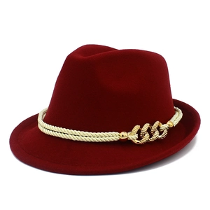 Close-up of burgundy fedora hat featuring woven rope band and golden metal chain buckle