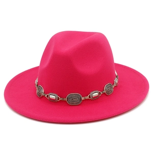 Detailed shot of fuchsia fedora hat with vintage bohemian style metal buckle chain decoration