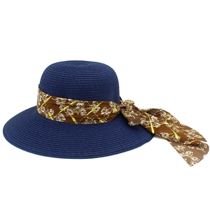 Close-up of the fine woven straw texture and floral ribbon on this navy sun hat