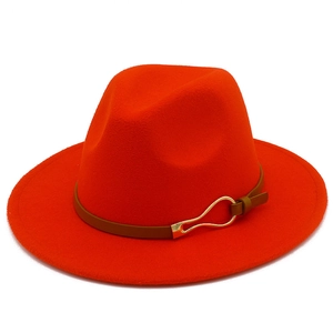 Detailed close-up of a red wide-brim fedora hat with a brown leather band and gold buckle