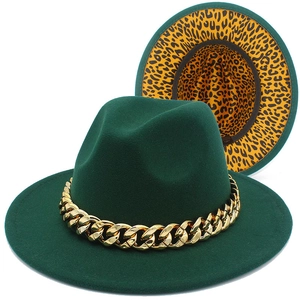 Detailed macro view of dark green wool fedora with bold gold Cuban link chain accessory