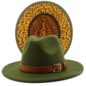 Detail of green fedora hat showing yellow leopard print underbrim and leather strap