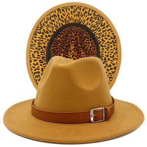 Detail of camel fedora hat featuring leopard print lining and brown leather belt buckle