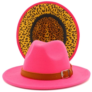 Detail of pink fedora with leopard print brim underside and brown leather belt buckle