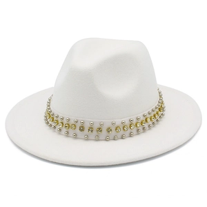 Détail d'un chapeau en laine blanche avec rivets argentés et strass en cristal jaune