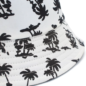 White cotton bucket hat with black palm tree patterns and Chinese character print
