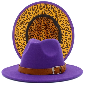 Detail of purple fedora hat with brown leather belt and yellow leopard print lining
